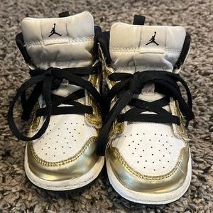 Kids used gold and white Jordan 1s